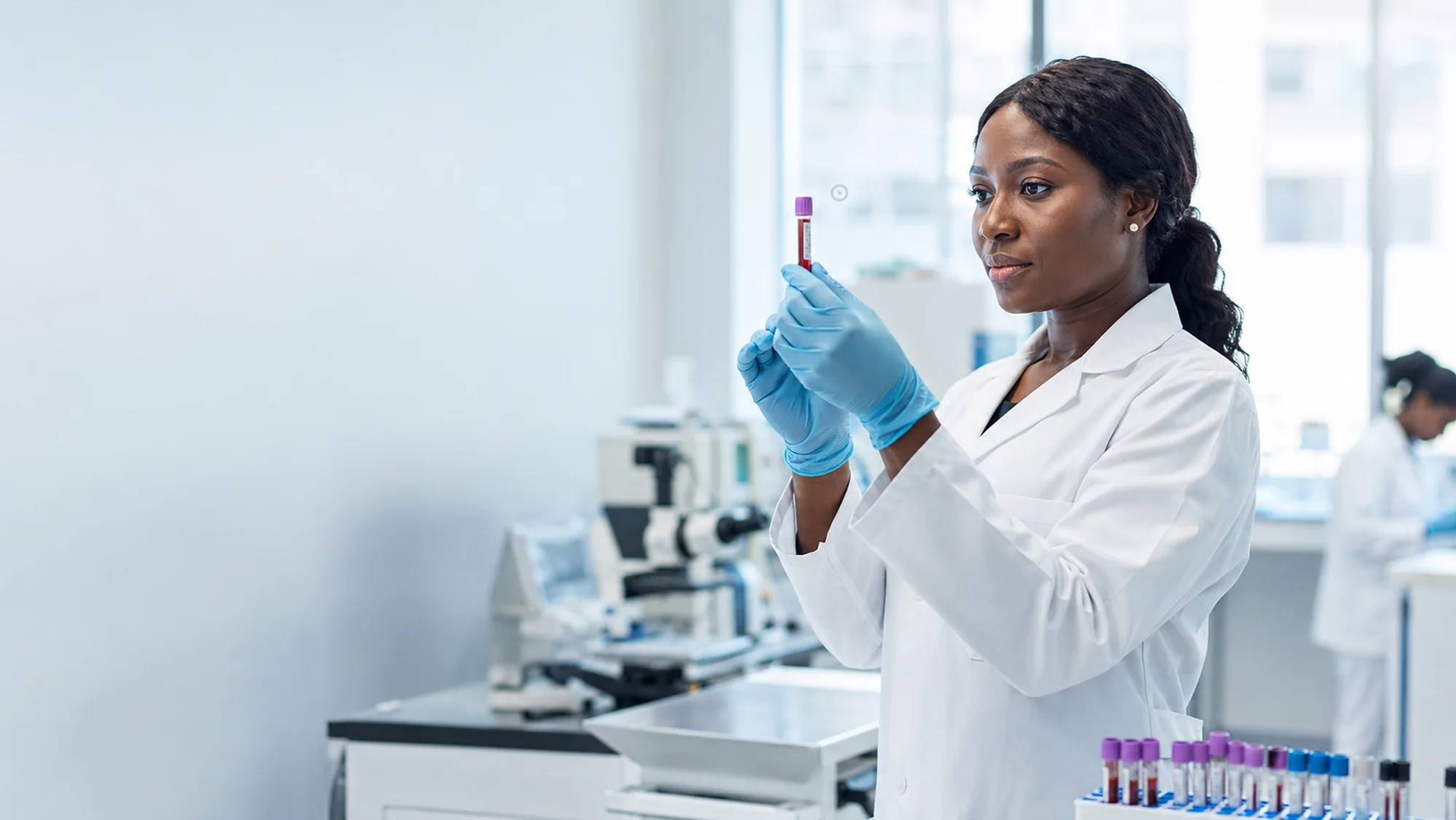 Nigerian medical laboratory scientist examining a blood sample